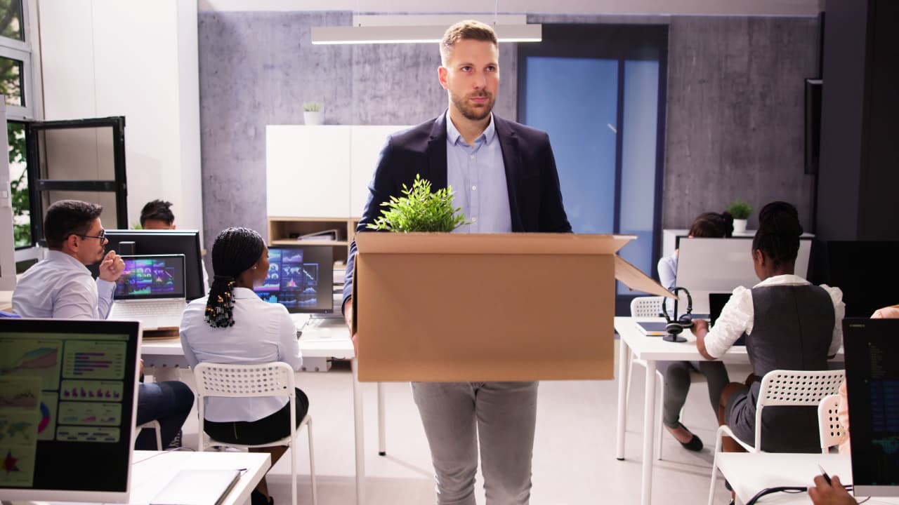 Employee losing his job and packing up his desk and leaving